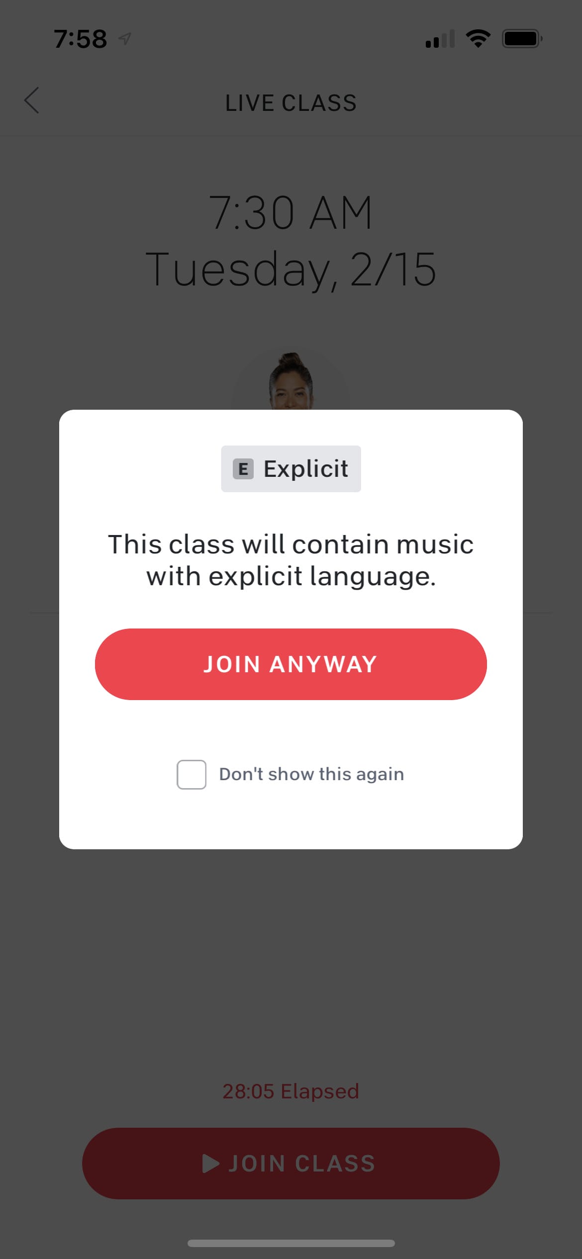 Explicit music pop-up notification on a live Peloton class.