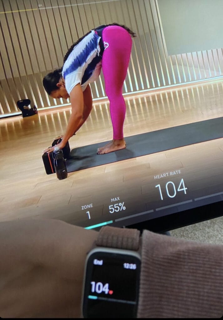 The Apple Watch heart rate is now seen on the Peloton Bike screen during a Yoga class.