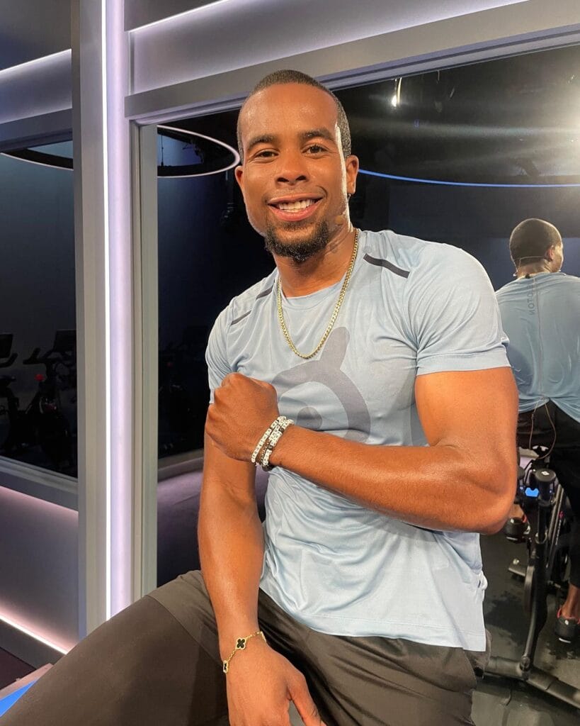 Alex Toussaint wearing his Peloton Little Words Project bracelet.